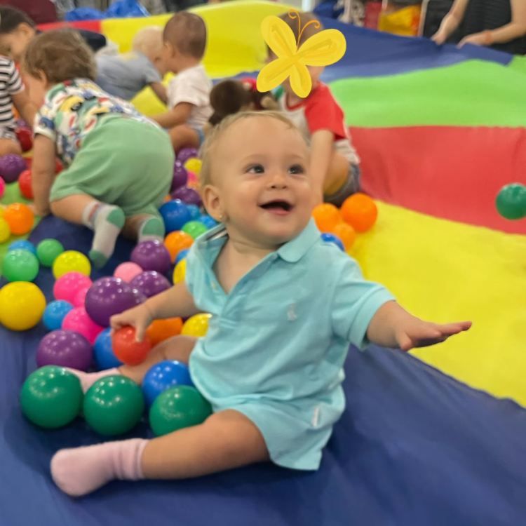 Interactive baby music class with parachute games and sensory ball activities