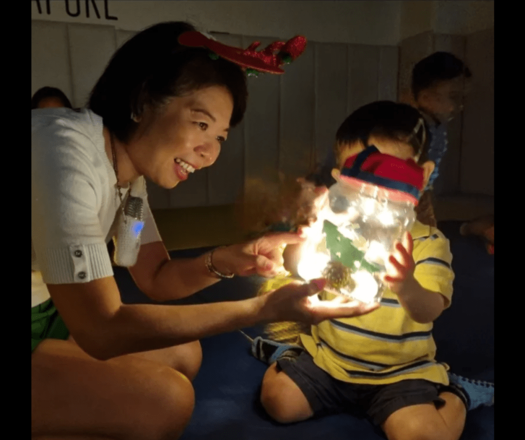 Baby and toddler sensory play with glowing lanterns during themed music session