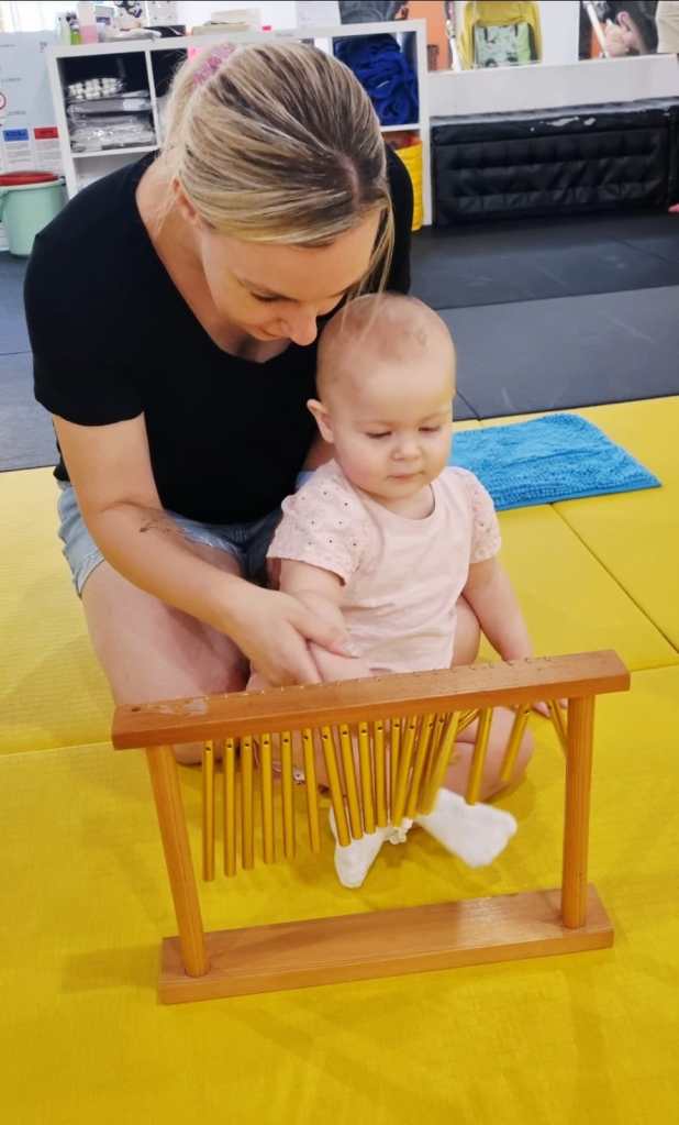 Parent and child exploring bar chimes